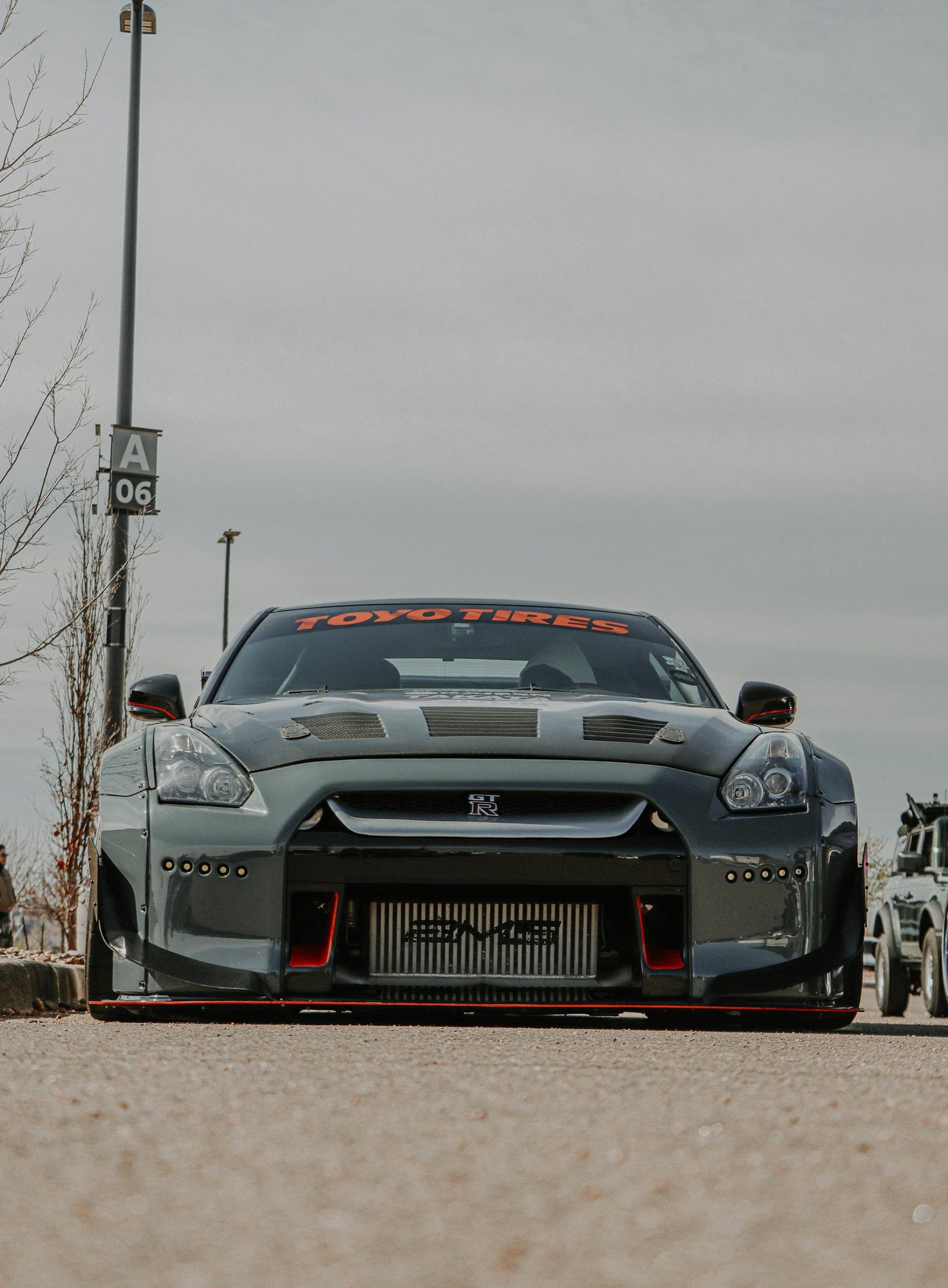 A powerful sports car, Nissan GT-R, parked outdoors, showcasing its sleek design.