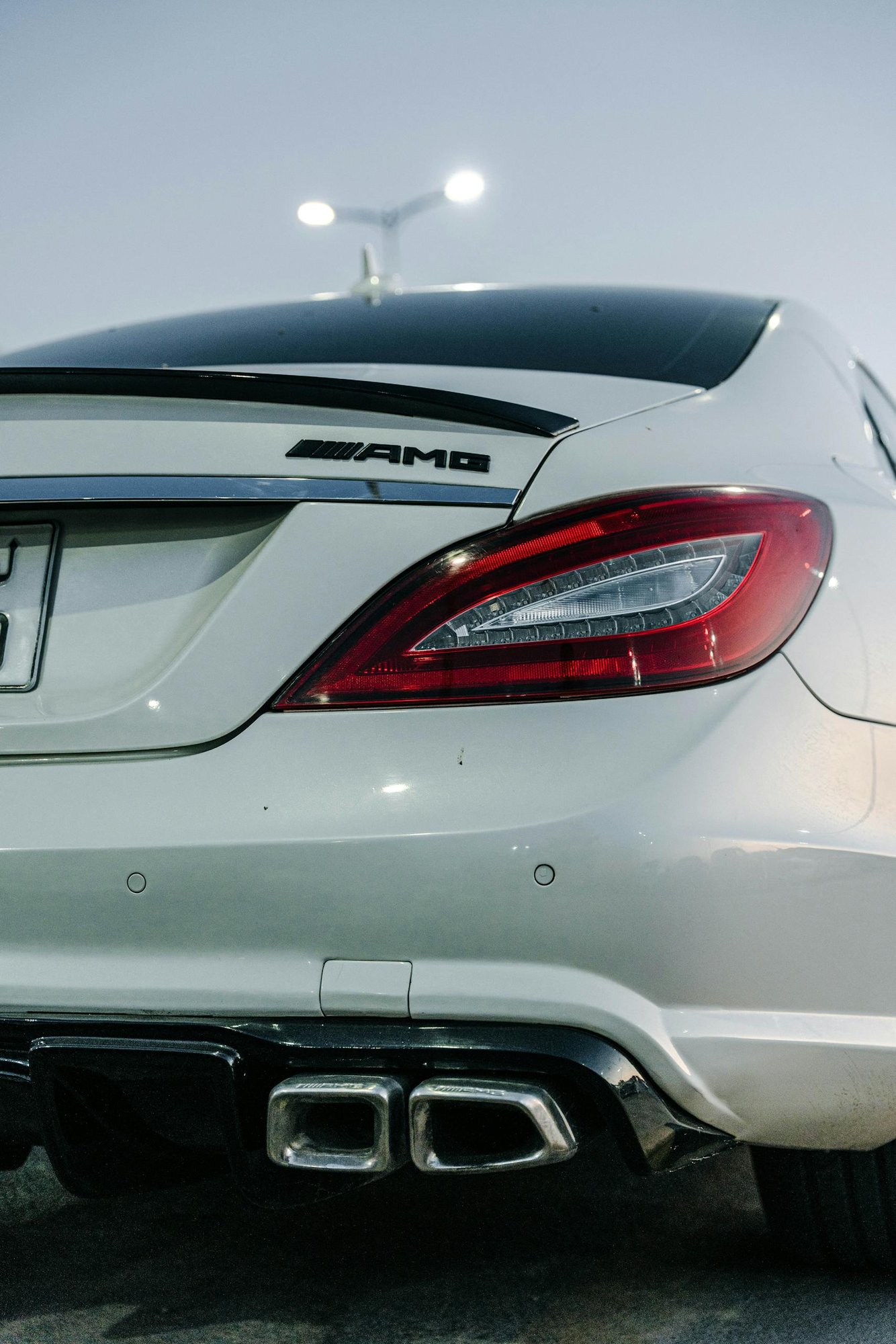 Rear view of a sleek white Mercedes-Benz AMG parked in Tripoli.